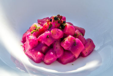 Homemade gnocchi with cheeses, peppers, beet and lime.